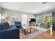 Bright living room featuring comfortable seating, a stylish rug, and plenty of natural light at 3330 E Tennessee Ave, Denver, CO 80209