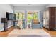 Bright living area showcases comfortable seating, hardwood floors, and access to the outdoor patio at 3330 E Tennessee Ave, Denver, CO 80209