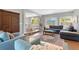 Open-concept living room features a large sectional sofa and seamlessly connects to the dining area and kitchen at 3330 E Tennessee Ave, Denver, CO 80209