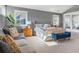 Spacious main bedroom featuring two windows, gray walls, with bench and sofa at 3330 E Tennessee Ave, Denver, CO 80209