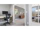 Bright office area with a view into the main bedroom and a modern desk setup at 3330 E Tennessee Ave, Denver, CO 80209