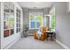 Sitting room features a comfortable armchair, large windows, and natural light at 3330 E Tennessee Ave, Denver, CO 80209