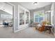 Sitting room features a comfortable armchair, large windows, and an entry to the main bedroom at 3330 E Tennessee Ave, Denver, CO 80209