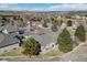 Aerial view of homes in a suburban neighborhood showing well manicured lawns and mature landscaping at 2059 June Ct, Castle Rock, CO 80104