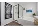 Modern bathroom featuring a glass-enclosed shower, soaking tub, and chic decor, blending style with relaxation at 2059 June Ct, Castle Rock, CO 80104