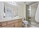 Bright bathroom featuring a glass shower, tiled flooring, and modern vanity at 2059 June Ct, Castle Rock, CO 80104