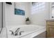 Close up of the bathroom showcasing a soaking tub with chrome hardware and a decorative art piece on the wall at 2059 June Ct, Castle Rock, CO 80104