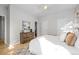 Bright bedroom featuring hardwood floors, a decorative dresser, and a calming neutral color palette at 2059 June Ct, Castle Rock, CO 80104