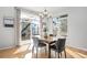 Bright dining area features light hardwood floors, sliding glass doors, and a modern chandelier at 2059 June Ct, Castle Rock, CO 80104