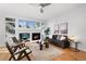 Cozy living room featuring a fireplace, hardwood floors, and large windows at 2059 June Ct, Castle Rock, CO 80104