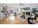 Bright and airy living room with hardwood floors, fireplace, and access to the dining area at 2059 June Ct, Castle Rock, CO 80104