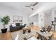 Bright living room with hardwood floors, ceiling fan, and neutral decor at 2059 June Ct, Castle Rock, CO 80104