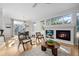 Bright and airy living room with hardwood floors, fireplace, and access to the dining area at 2059 June Ct, Castle Rock, CO 80104