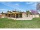 An outdoor covered patio and a well-maintained backyard create an inviting space for relaxation and entertainment at 5460 S Locust St, Greenwood Village, CO 80111