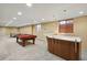 Finished basement with a pool table, bar area, and ping pong table at 5460 S Locust St, Greenwood Village, CO 80111