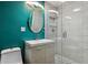 A contemporary bathroom has a glass shower, sleek vanity, and green accent wall at 5460 S Locust St, Greenwood Village, CO 80111