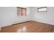 This bright bedroom features hardwood floors and ample natural light at 5460 S Locust St, Greenwood Village, CO 80111