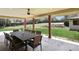 Spacious covered patio area with views of a well-maintained backyard and mature trees at 5460 S Locust St, Greenwood Village, CO 80111