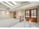 Bright entryway with skylights, double front doors, neutral carpet, and white tile flooring at 5460 S Locust St, Greenwood Village, CO 80111