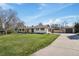 Spacious ranch-style home featuring a detached garage and expansive driveway, set on a large lot at 5460 S Locust St, Greenwood Village, CO 80111
