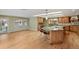 Open kitchen features wood cabinets, granite countertops, hardwood floors, and a breakfast bar area at 5460 S Locust St, Greenwood Village, CO 80111