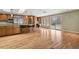 Open kitchen features wood cabinets, stainless steel appliances, granite countertops, and hardwood floors at 5460 S Locust St, Greenwood Village, CO 80111