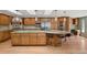 Large kitchen showcases wood cabinets, stainless steel appliances, granite countertops, and seating for four at 5460 S Locust St, Greenwood Village, CO 80111