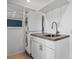 A compact laundry area showcases a stacked washer/dryer and a convenient utility sink at 5460 S Locust St, Greenwood Village, CO 80111