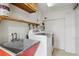 Laundry room includes utility sink, shelving and modern washer and dryer at 5460 S Locust St, Greenwood Village, CO 80111