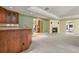 Living room with a fireplace, bar area, and open access to the adjacent kitchen at 5460 S Locust St, Greenwood Village, CO 80111