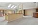 Bright living room with skylights, wood accents, and view of the kitchen and entryway at 5460 S Locust St, Greenwood Village, CO 80111