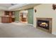 Lower level living room with fireplace and bar area, opening into a kitchen space at 5460 S Locust St, Greenwood Village, CO 80111