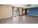 Bright living room featuring wood floors, natural light, french doors, and stylish curtains at 5460 S Locust St, Greenwood Village, CO 80111