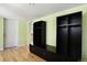 Mudroom features built-in black cabinets, drawers, hooks, and hardwood floors at 5460 S Locust St, Greenwood Village, CO 80111