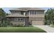 Charming two-story home with stone accents, a well-manicured lawn, and an attached two-car garage at 5762 Las Rosas Dr, Parker, CO 80134