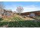 Backyard featuring a stone patio, mature trees, and privacy fence at 11785 W Belleview, Littleton, CO 80127