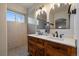 Bathroom featuring double sink vanity with stylish mirrors and modern fixtures at 11785 W Belleview, Littleton, CO 80127