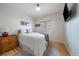 Bedroom with a cozy bed, natural light, and a wooden dresser for storage at 11785 W Belleview, Littleton, CO 80127