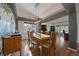 Well-lit dining room boasting hardwood floors, modern light fixture and a view of the adjacent living room and office at 11785 W Belleview, Littleton, CO 80127