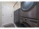 Laundry room features stacked washer/dryer and built-in storage with a utility sink at 11785 W Belleview, Littleton, CO 80127