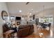 Bright, open-concept living space with hardwood floors, a cozy fireplace, and seamless flow into the modern kitchen at 11785 W Belleview, Littleton, CO 80127