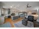 Spacious open-concept living room with vaulted ceilings, hardwood floors, and seamless flow into the modern kitchen at 11785 W Belleview, Littleton, CO 80127