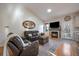 Comfortable living room with a cozy fireplace, hardwood floors, vaulted ceiling, and view into the kitchen at 11785 W Belleview, Littleton, CO 80127