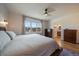 Bright main bedroom offers lots of sunlight with a dresser and ensuite bathroom access at 11785 W Belleview, Littleton, CO 80127