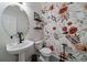 Charming powder room boasts a floral wallpaper accent wall and a modern vessel sink at 11785 W Belleview, Littleton, CO 80127