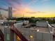 Image shows a stunning rooftop view with the cityscape in the background during sunset at 1644 Little Raven St, Denver, CO 80202