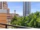 Image shows skyline views overlooking lush green trees from a balcony with metal railings at 1644 Little Raven St, Denver, CO 80202