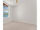 Simple, carpeted bedroom with ample natural light from the large window at 1644 Little Raven St, Denver, CO 80202