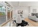 Elegant dining area featuring a glass table, plush chairs, and plenty of natural light from sliding glass doors at 1644 Little Raven St, Denver, CO 80202