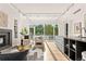 Bright living space with hardwood floors, a fireplace, and expansive windows showcasing picturesque outdoor views at 1644 Little Raven St, Denver, CO 80202